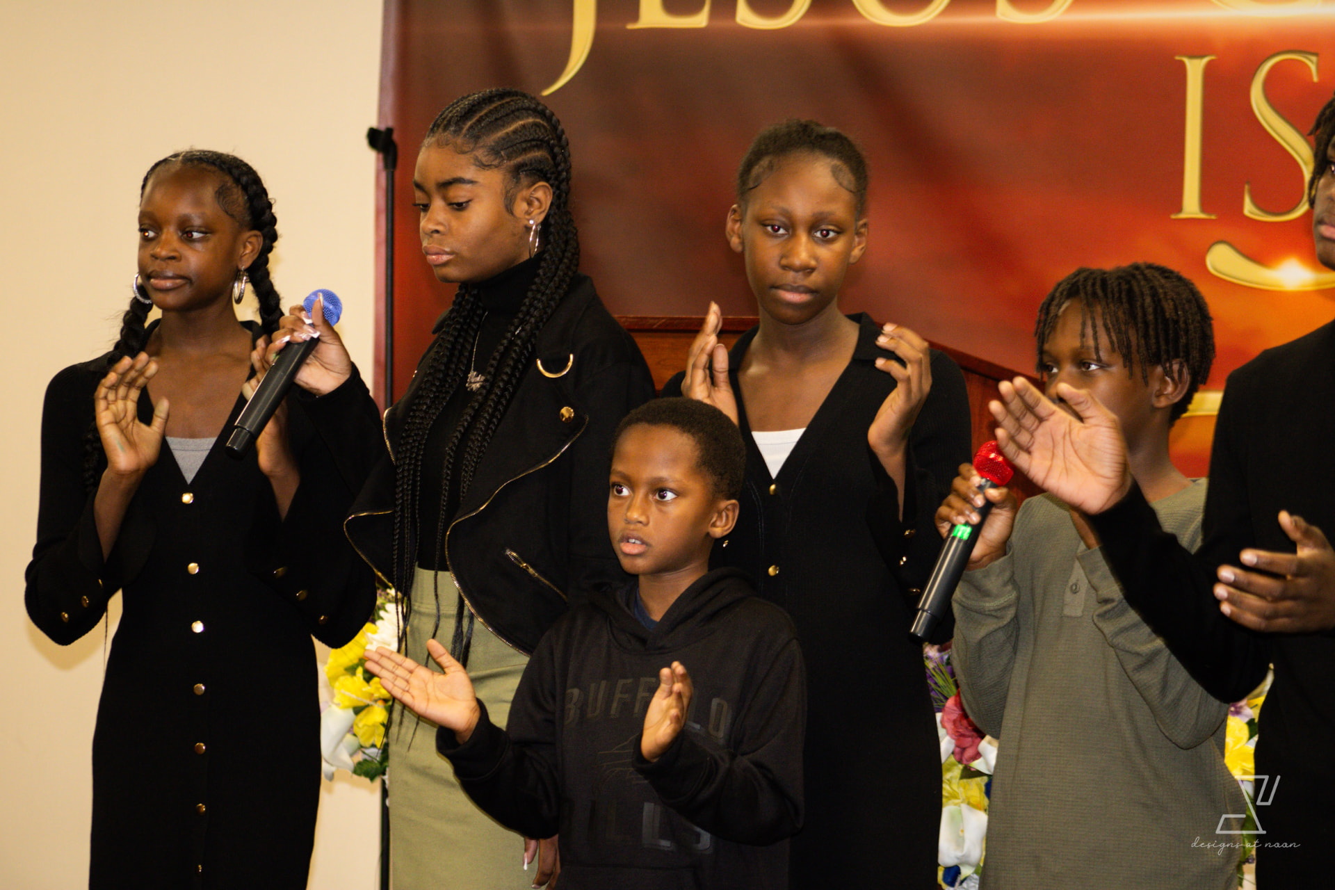 Youth choir clapping and singing during service