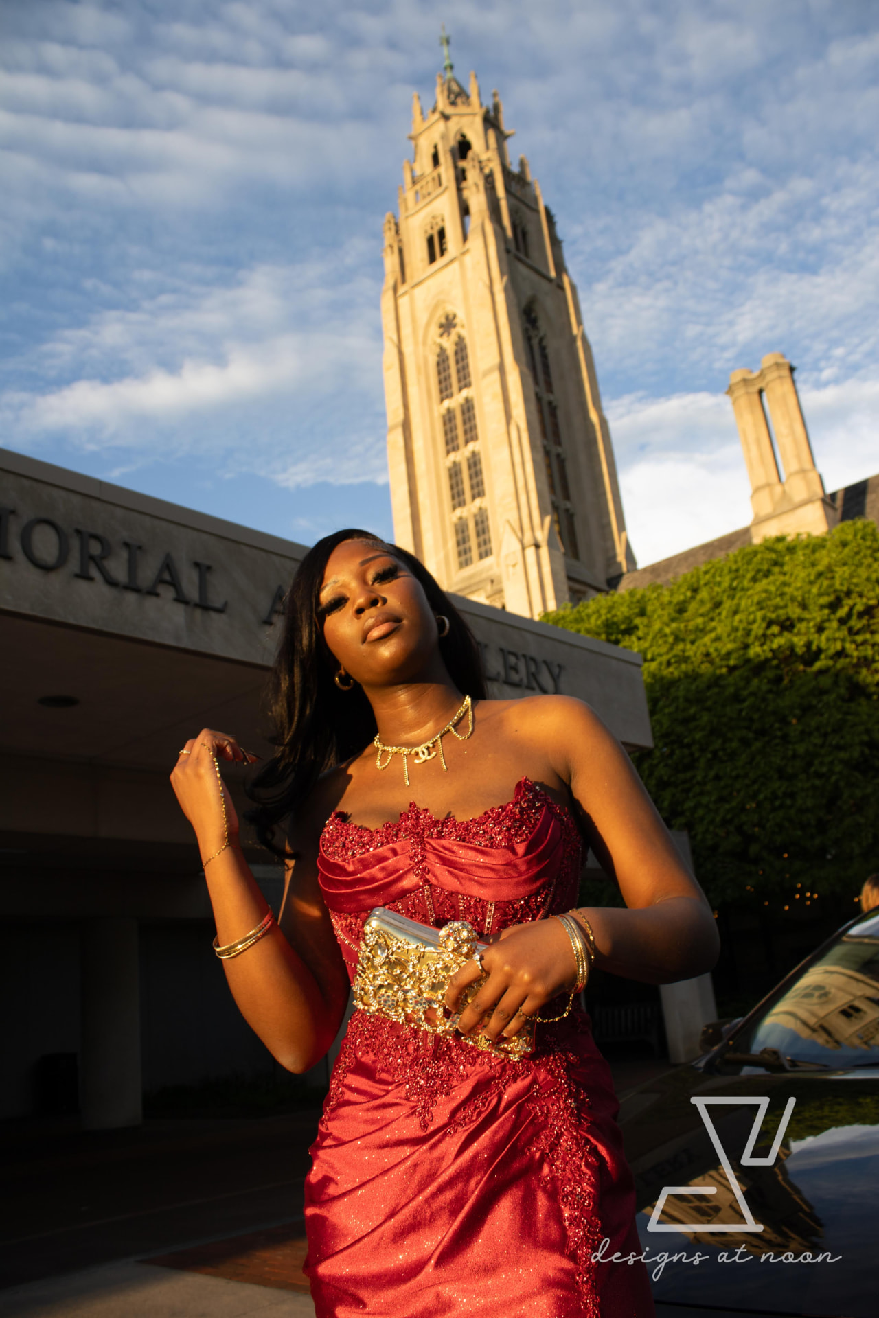 Prom portrait in a red beaded gown outside the Memorial Art Gallery at golden hour